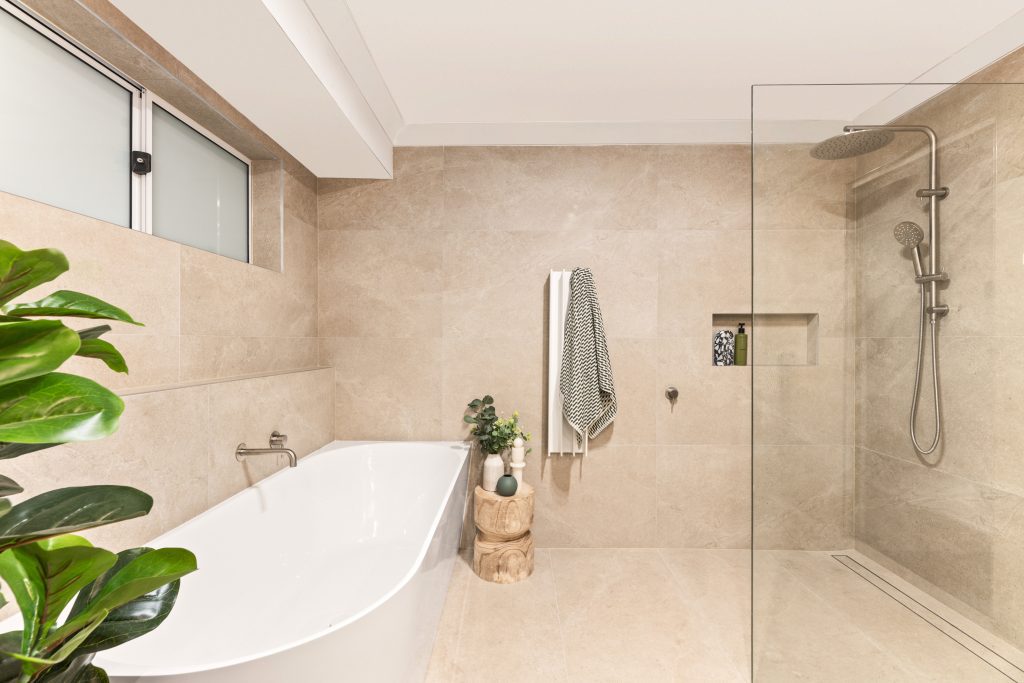 Modern bathroom with freestanding tub and walk-in shower by Dura Group by Dura Group