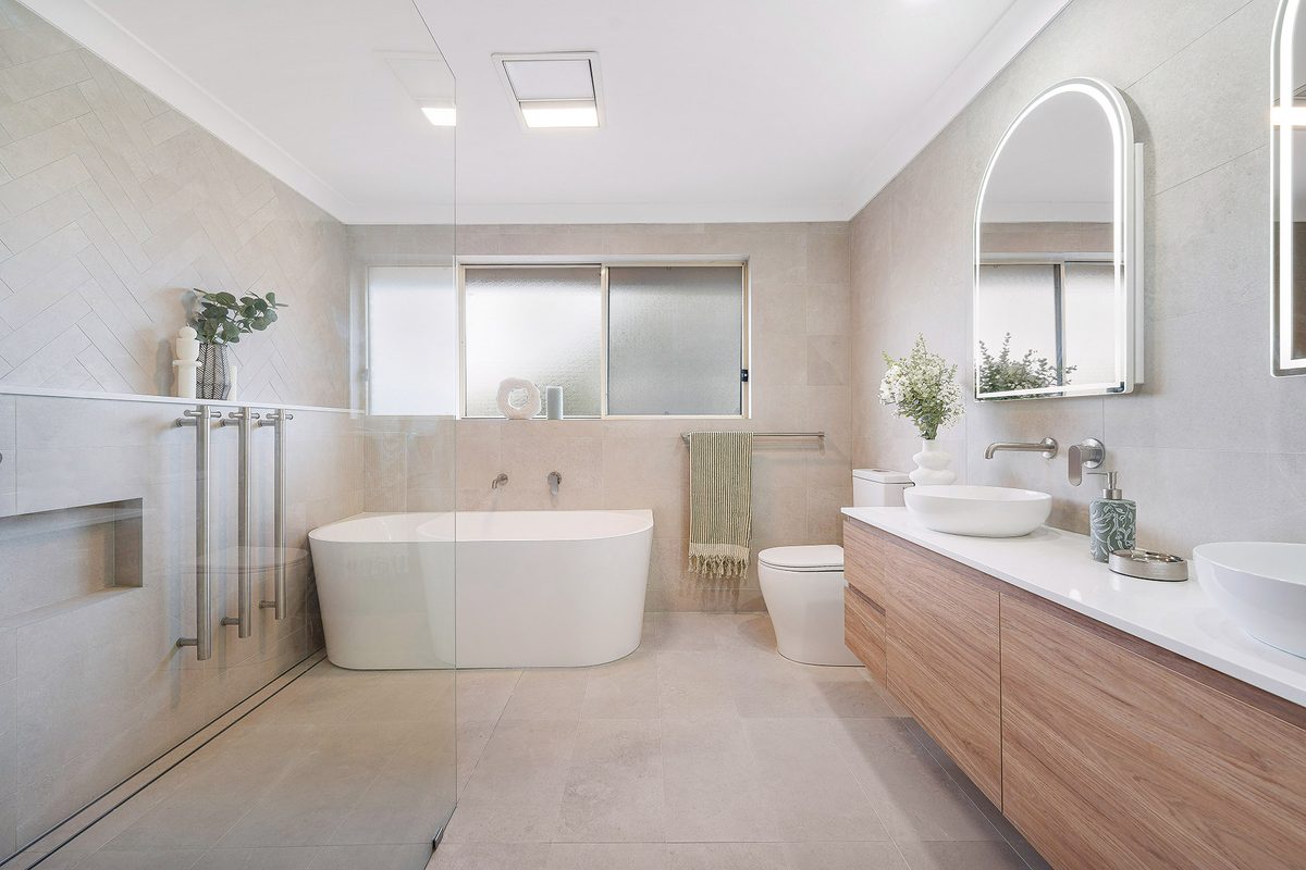 Bathroom renovation with freestanding bath and arched mirror