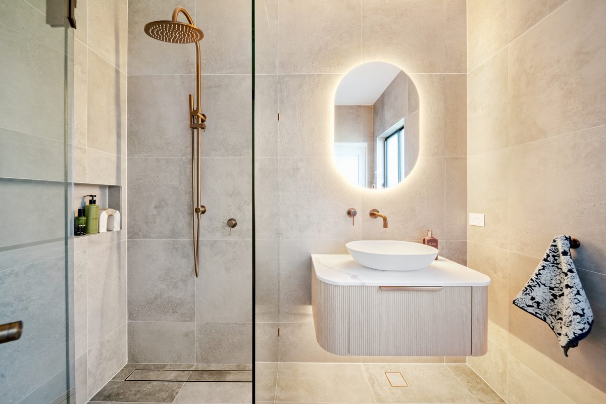 Bathroom renovation with walk-in shower and brushed gold tapware