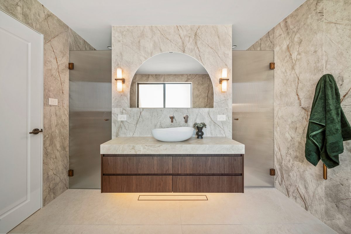 Ensuite renovation with arched alcove and timber vanity