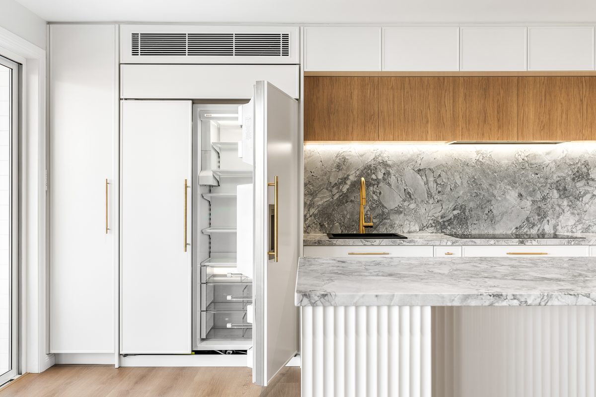 Kitchen renovation with integrated fridge and stone splashback